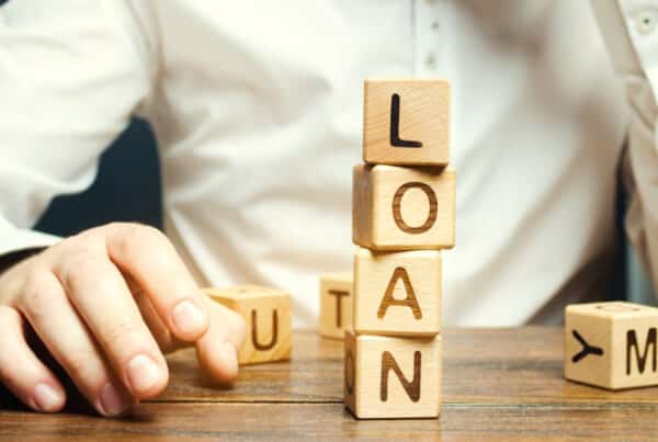 Financial professionals comparing installment loan and line of credit performance data in a modern office setting